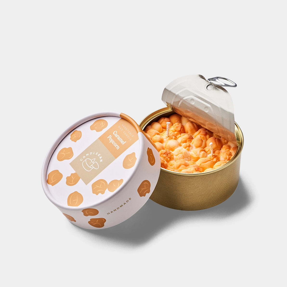 Caramel Popcorn candle in sealed tin with lid opened, showing ultra-realistic popcorn-shaped wax and stylish packaging design.