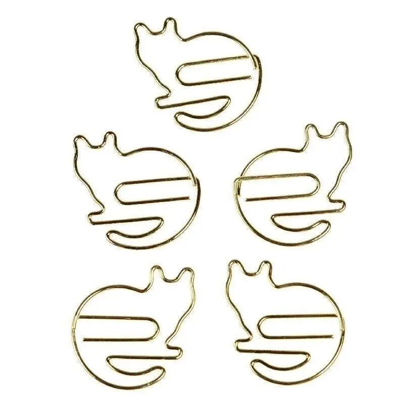 Set of 5 gold cat-shaped paper clips arranged on white background.