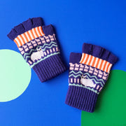 Catnip Fair Isle fingerless gloves in navy blue with orange stripes, pink and green knit pattern, and embroidered white cat detail – flat lay on bold blue background.