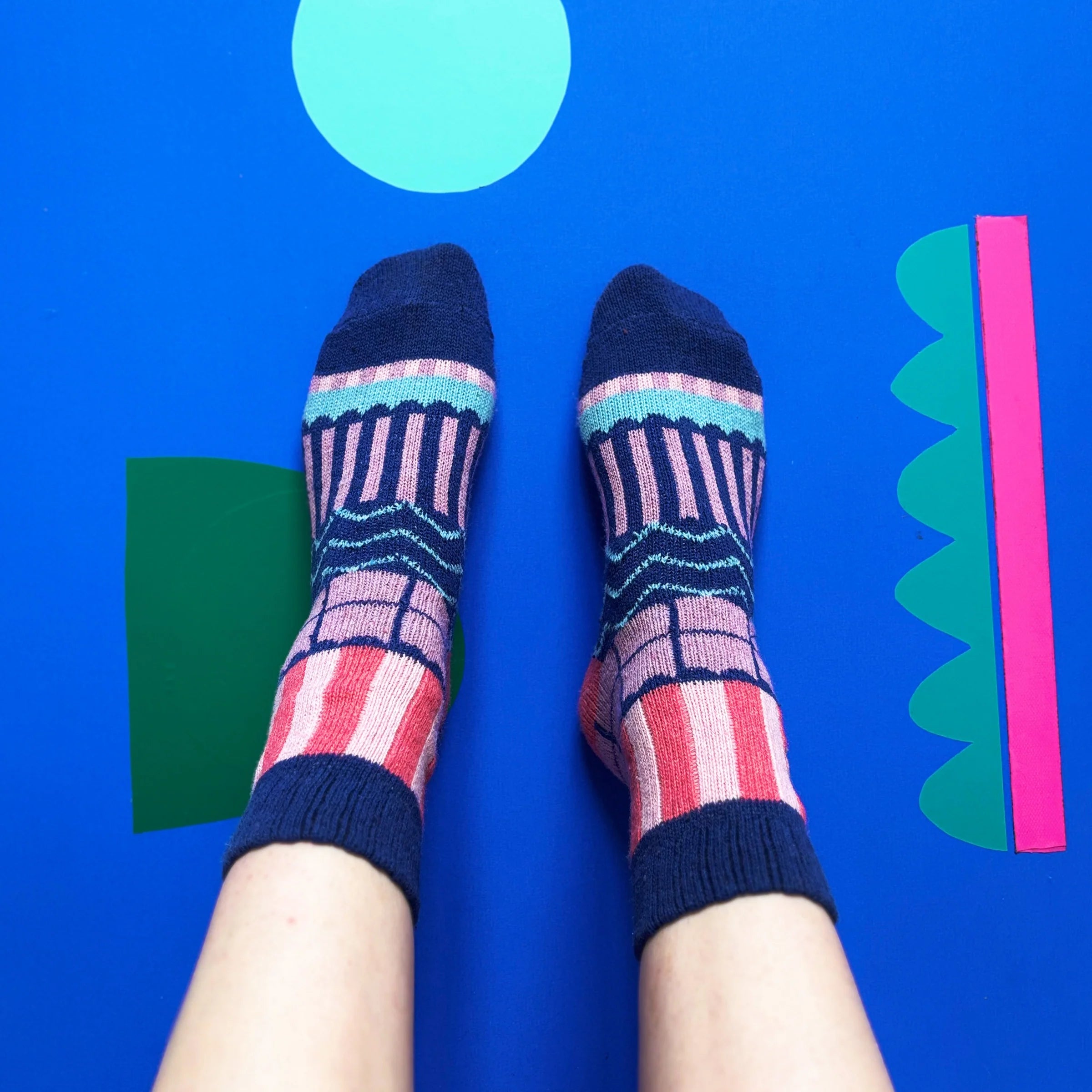Top view of Catnip Fair Isle Socks on feet showing vibrant geometric knit and cat motif.