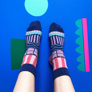 Top view of Catnip Fair Isle Socks on feet showing vibrant geometric knit and cat motif.