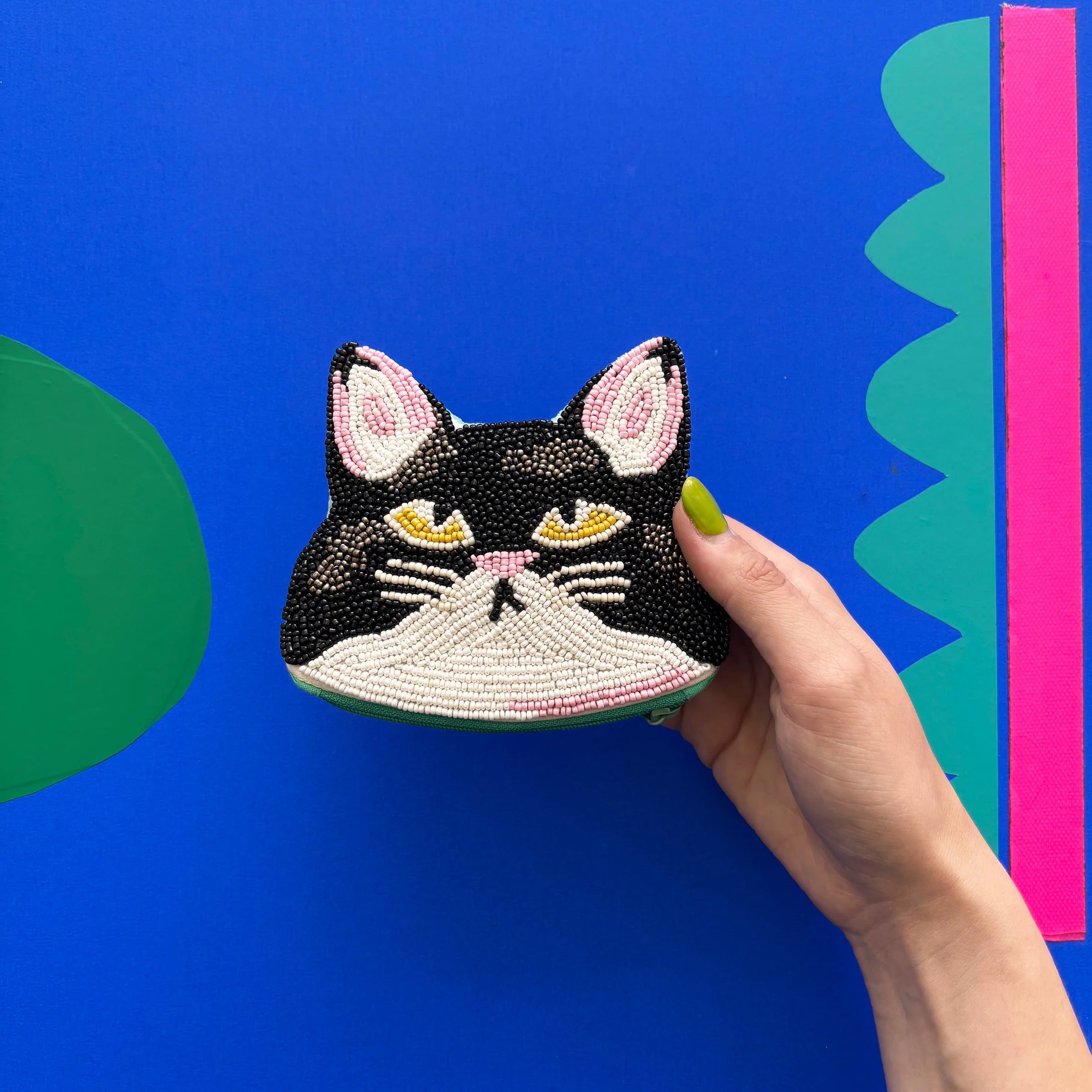 Hand holding Catnip Cat Coin Purse showing beaded cat face detail.