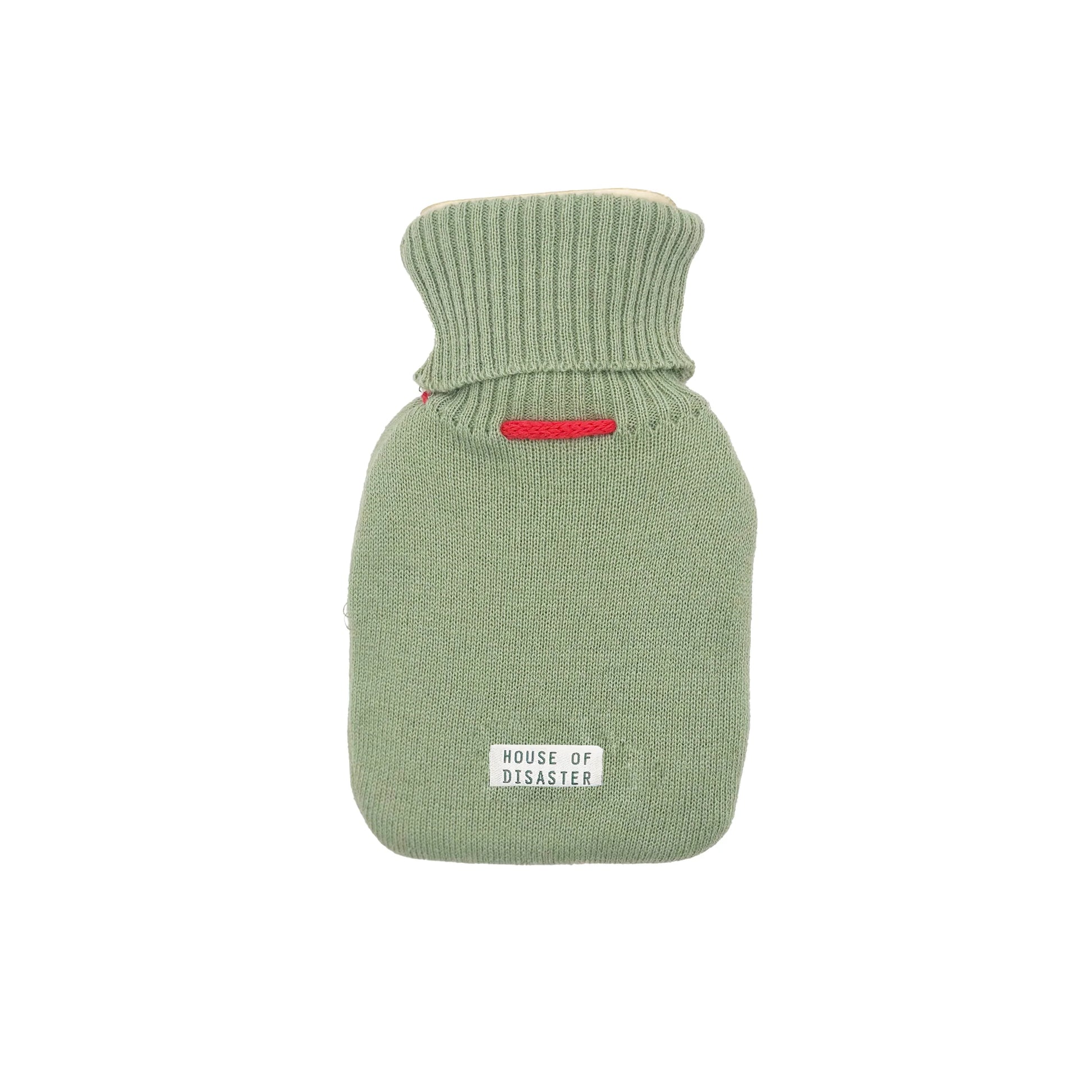 Back view of green knitted hot water bottle cover with House of Disaster label.