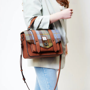 Model carrying the Islander Harris Tweed Satchel with crossbody strap, styled with casual outfit.