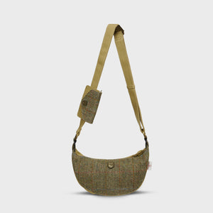 A chestnut herringbone Harris Tweed Luna bag with a matching purse attached, on a white background.