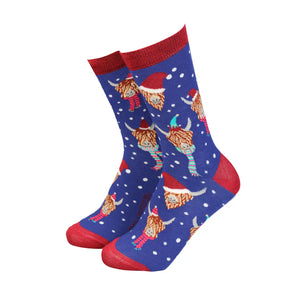 Women’s Christmas Highland Cow bamboo socks in blue with red trim, featuring Highland cows in Santa hats and scarves with snowflake pattern.
