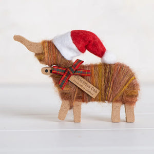 Handmade Christmas Standing Highland Coo Ornament with Santa hat and tartan ribbon bow, Scottish Highland cow decoration, 8 × 12 × 1.5 cm.