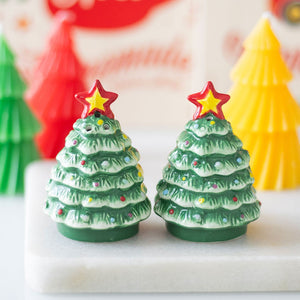 Front view of ceramic Christmas tree salt and pepper shakers with red star toppers.