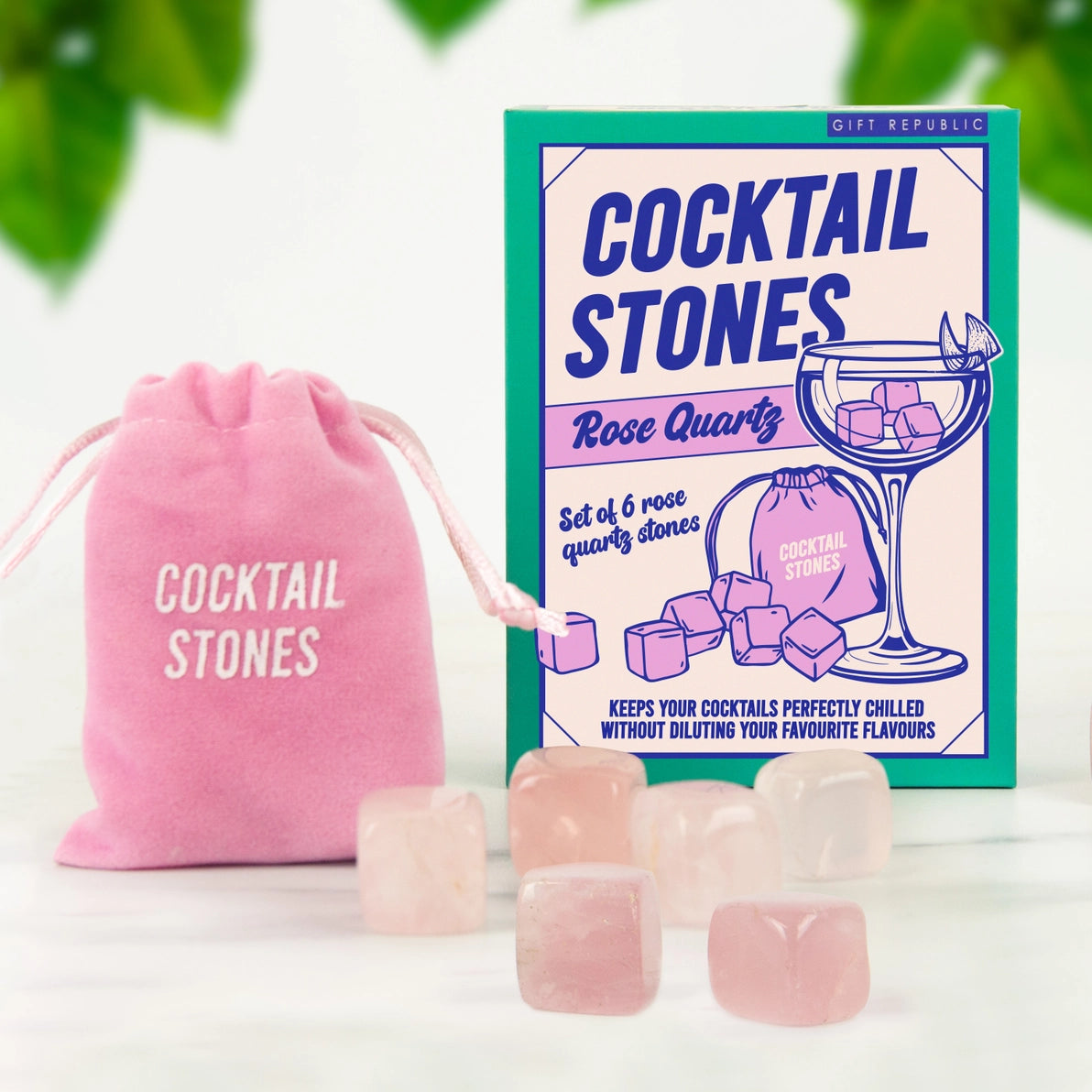Front view of rose quartz cocktail stones set with six pink crystal cubes, pink velvet drawstring pouch, and illustrated gift box packaging.