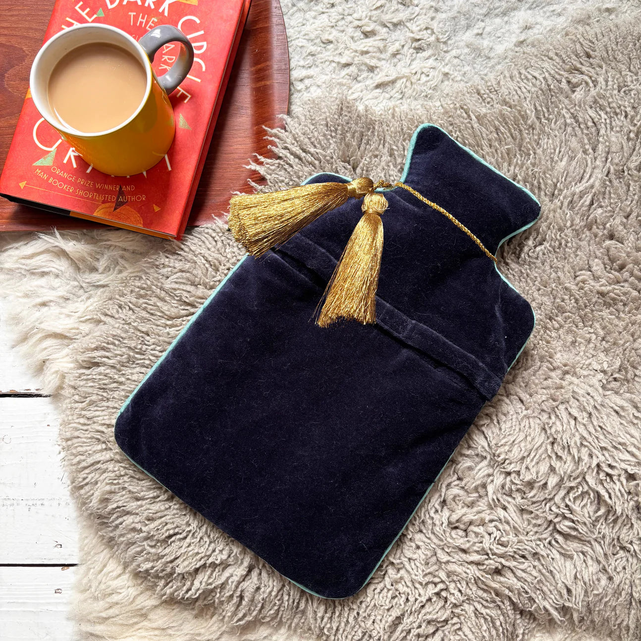 Back view of Coral Lobster Hot Water Bottle – plain navy velvet with gold tassel detail.