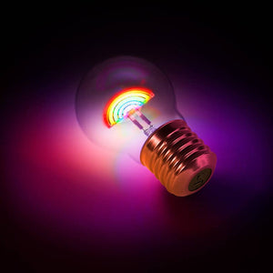 Rainbow LED lightbulb glowing on a dark surface – rechargeable pride-themed desk light
