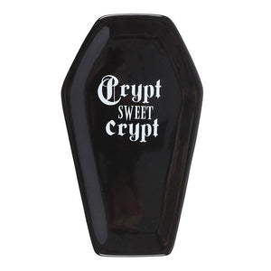 Top view of black coffin-shaped trinket tray with gothic lettering.
