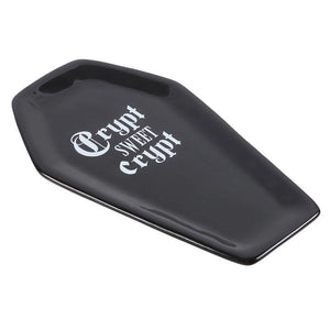 Side angle view of coffin-shaped trinket dish showing depth and glossy finish.