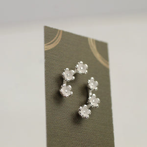 Daisy Chain Silver Earrings displayed on a presentation card.