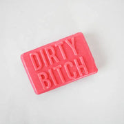 Bright pink bar of novelty soap embossed with the phrase “Dirty Bitch” on a white background.