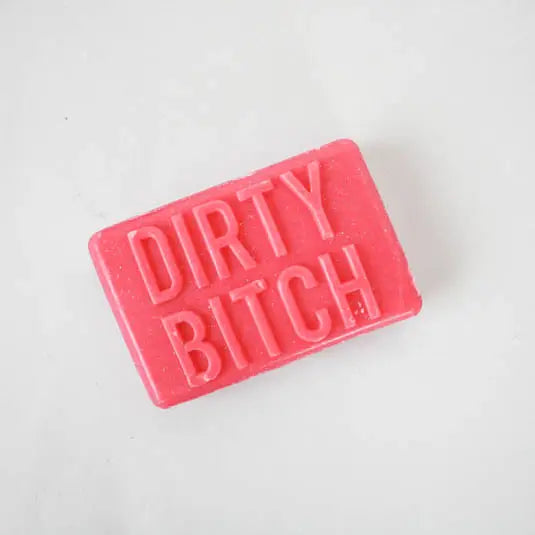 Bright pink bar of novelty soap embossed with the phrase “Dirty Bitch” on a white background.