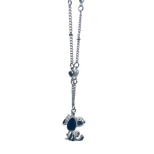 A side view of the Snoopy charm pendant hanging from the silver chain.