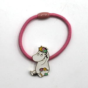 A close-up of the Snorkmaiden Enamel Hairband, showing the pink fabric-covered elastic and the detailed enamel charm of Snorkmaiden with floral accents.