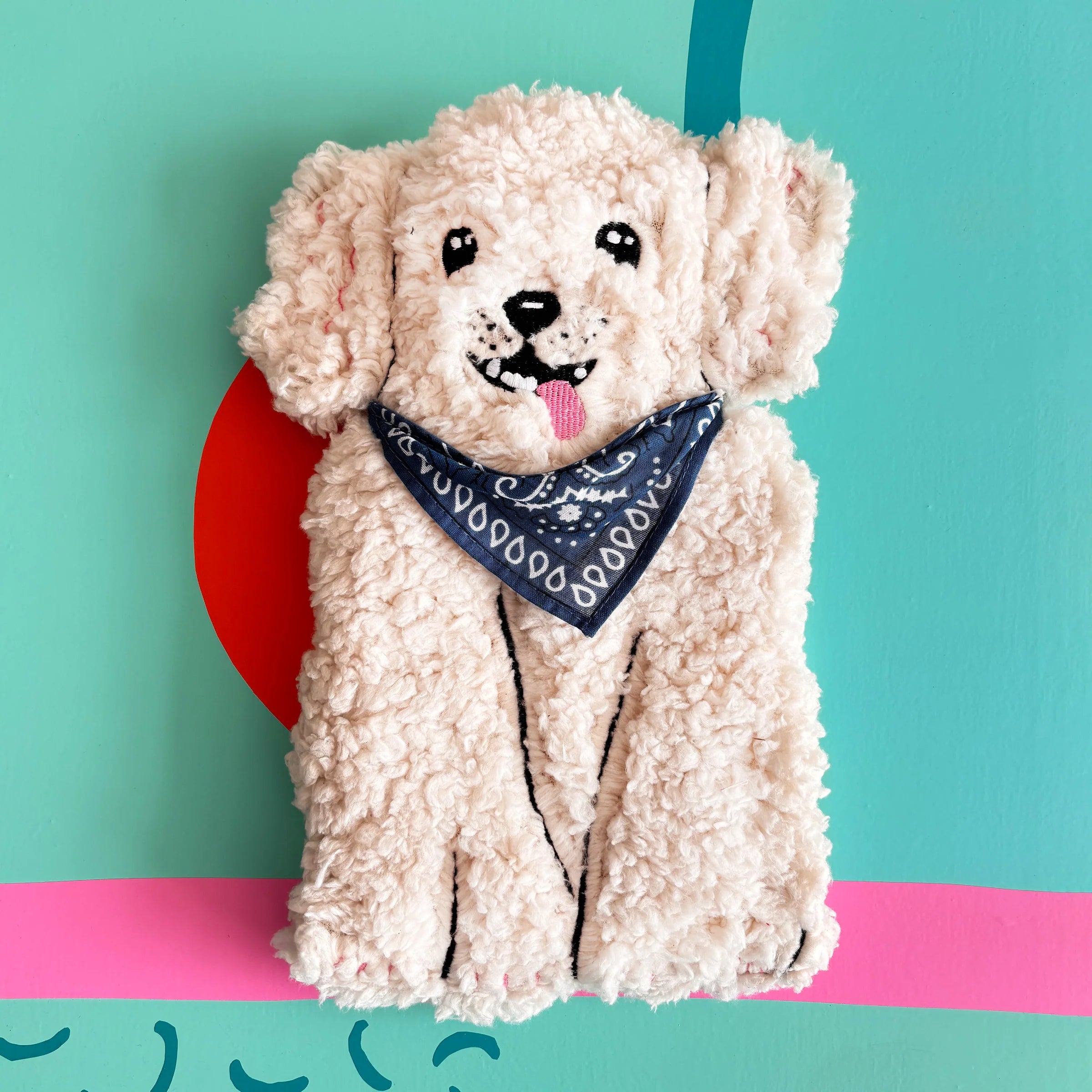 Dog Hot Water Bottle with boucle fabric and blue bandana on colourful background.