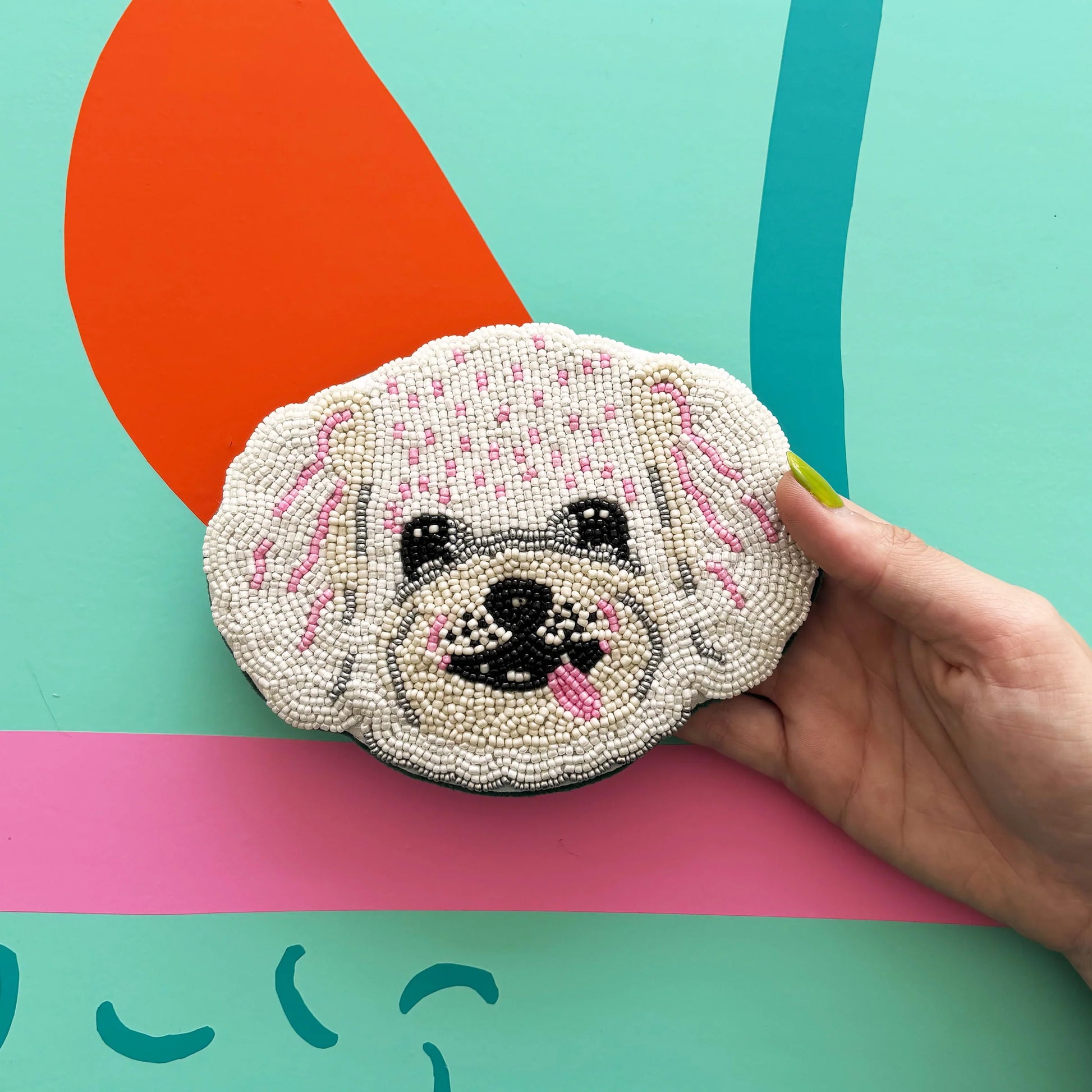 Close-up of Dog House Coin Purse showing hand-beaded dog face.