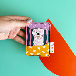 Dog House Dog Card Holder front design with white dog illustration on colourful background.