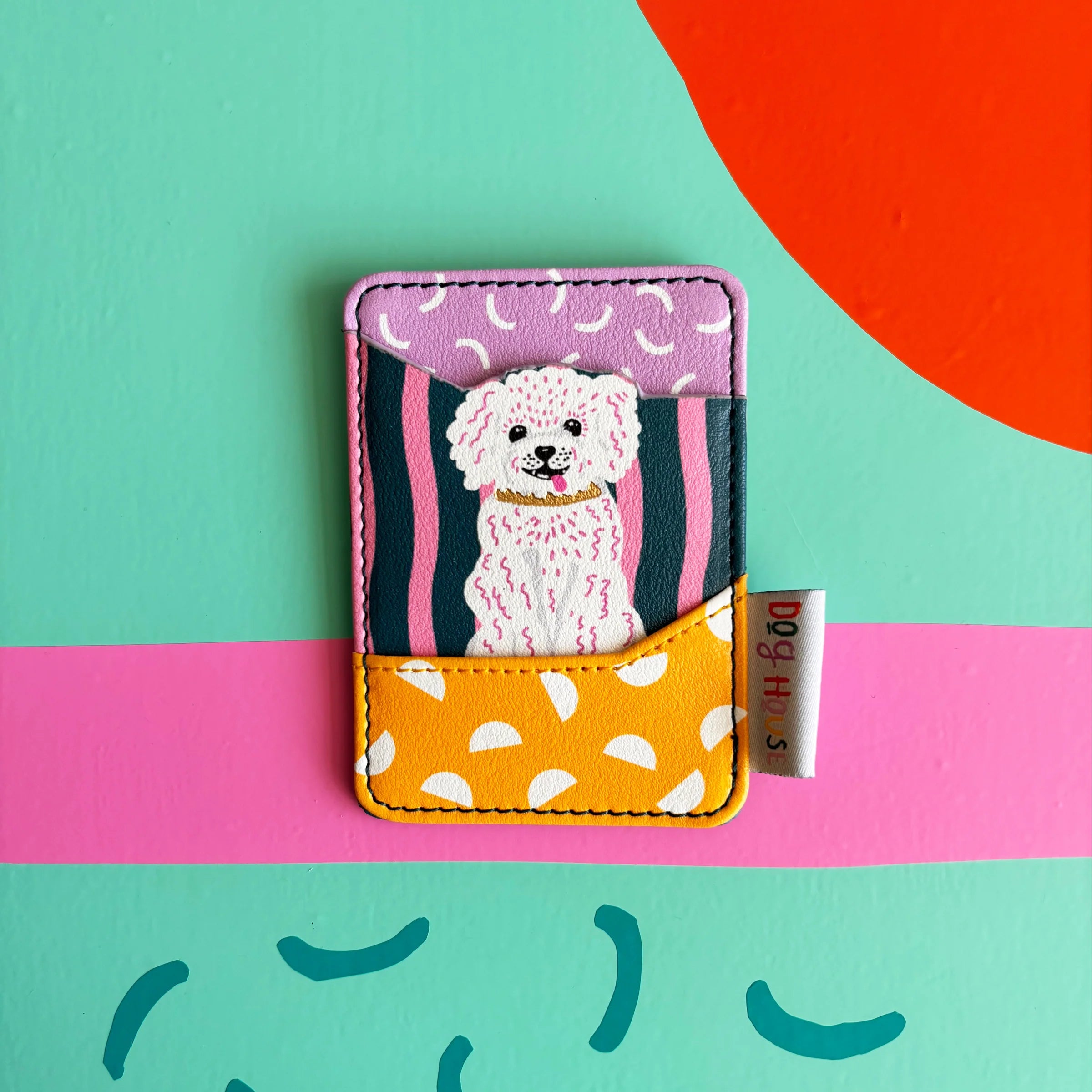 Close-up of Dog House Dog Card Holder showing vibrant stripes and polka dots.
