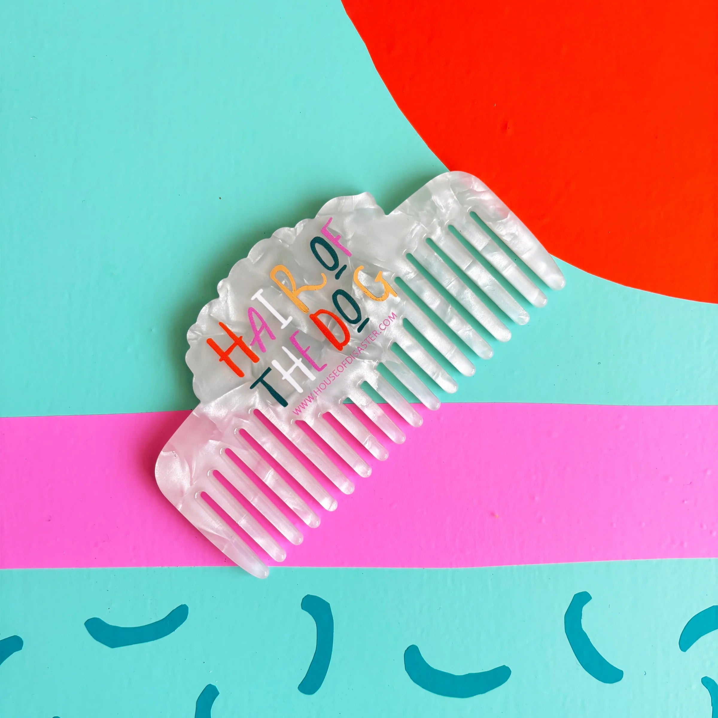 Back of pearlescent comb showing ‘Hair of the Dog’ text – Dog House Hair of the Dog Comb design.