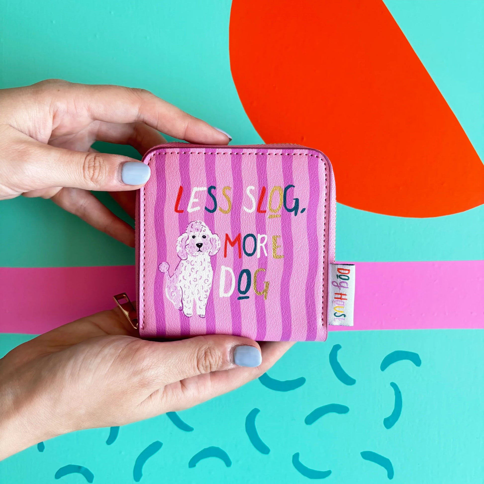 Dog House Purse with pink striped front and “Less Slog, More Dog” slogan held in hands.