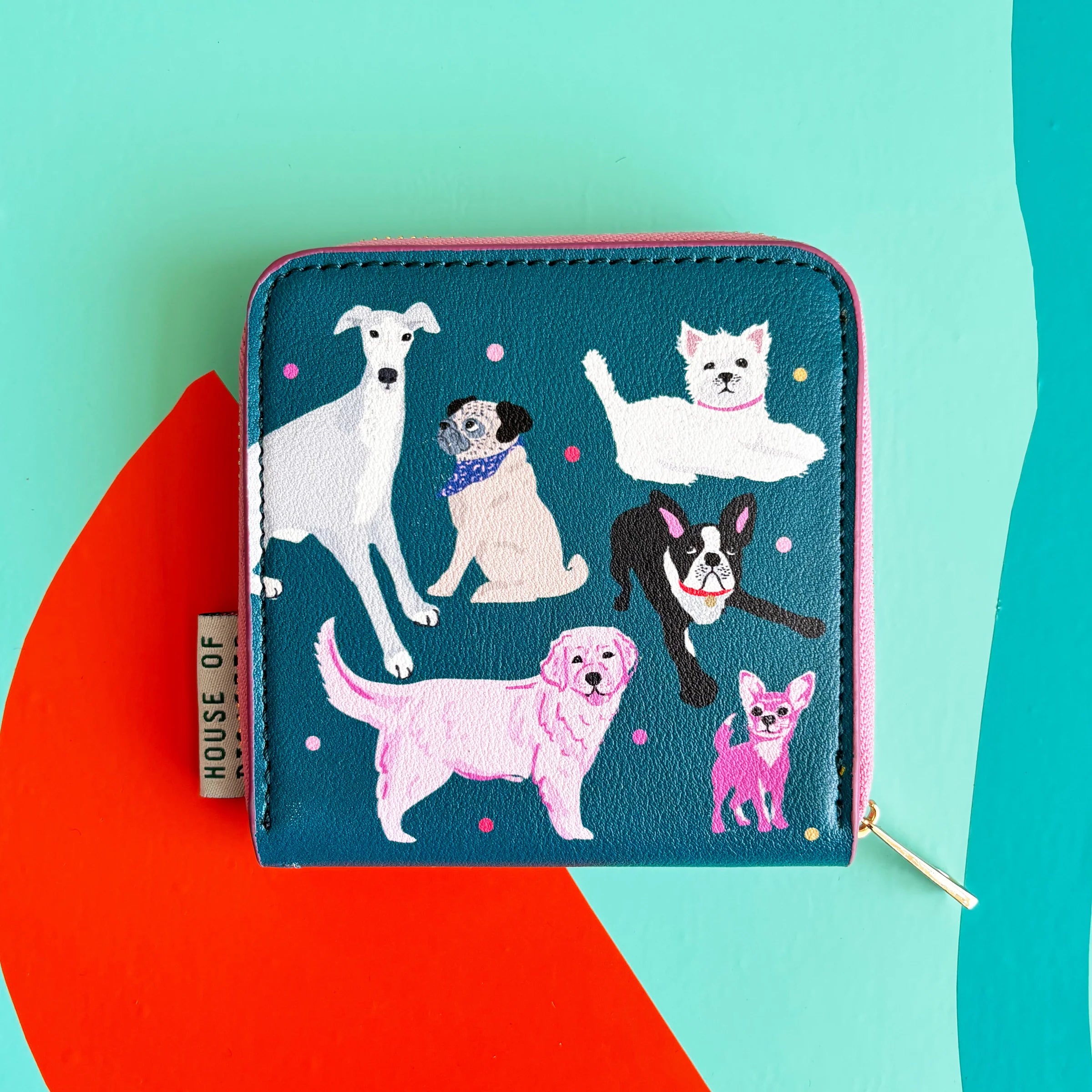 Green side of Dog House Purse with playful illustrated dogs on bright background.
