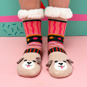 Model wearing fluffy-lined Dog House Slipper Socks on pink floor.