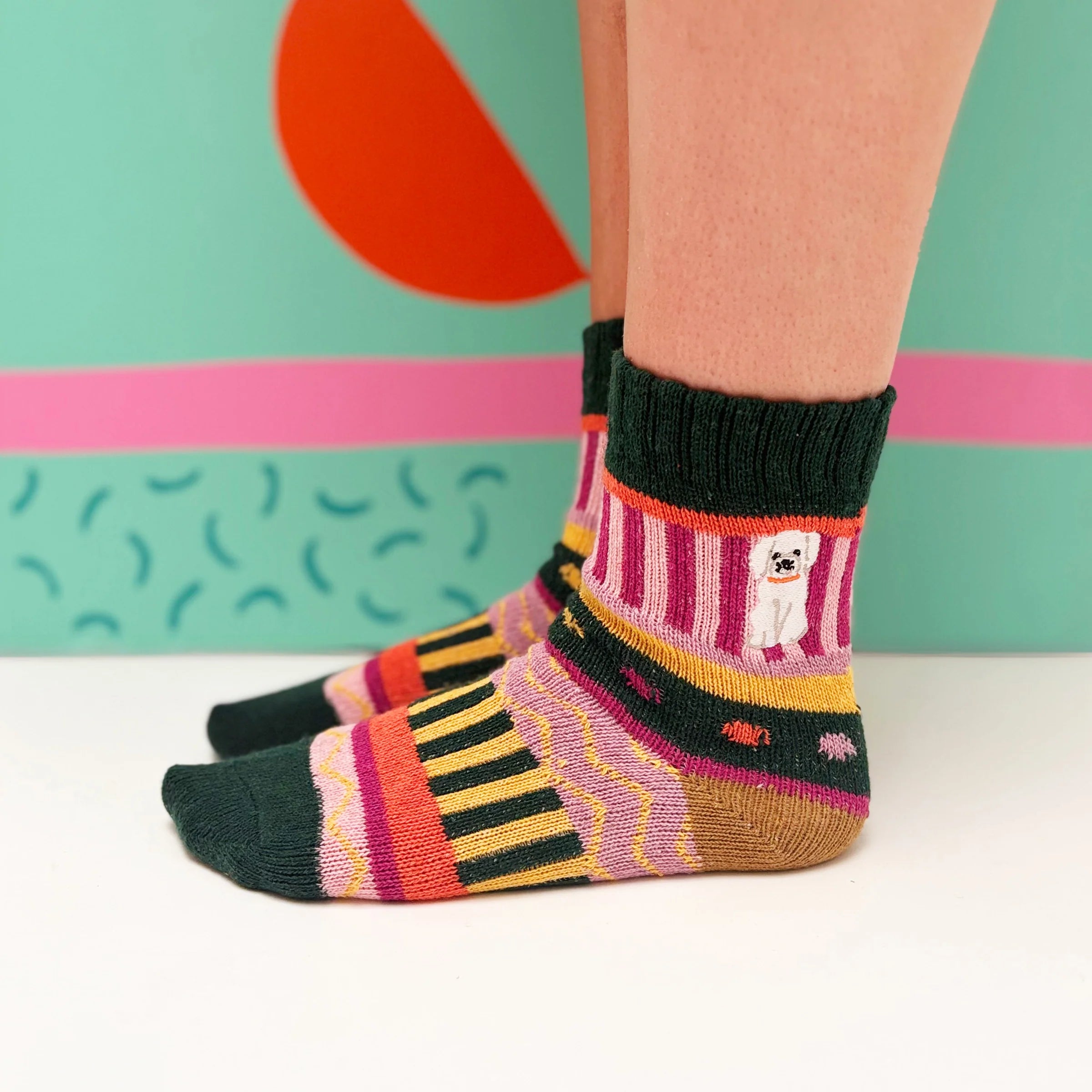 Side view of socks showing playful knit pattern and dog embroidery.