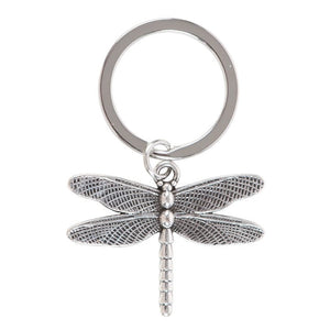 Close-up of metal dragonfly charm keyring with intricate wing details.