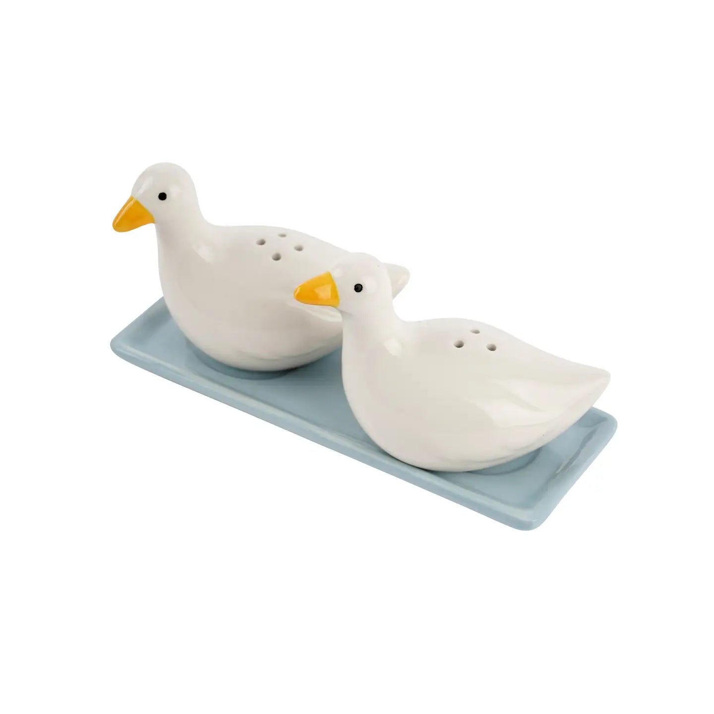 Pair of duck salt and pepper shakers photographed on a kitchen counter with soft lighting and natural tones.