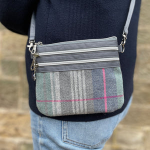 Earth Squared Tweed 3 Zip Pouch Bag: A person wearing a Drem Tweed 3 Zip Pouch Bag, demonstrating its comfortable and practical design.