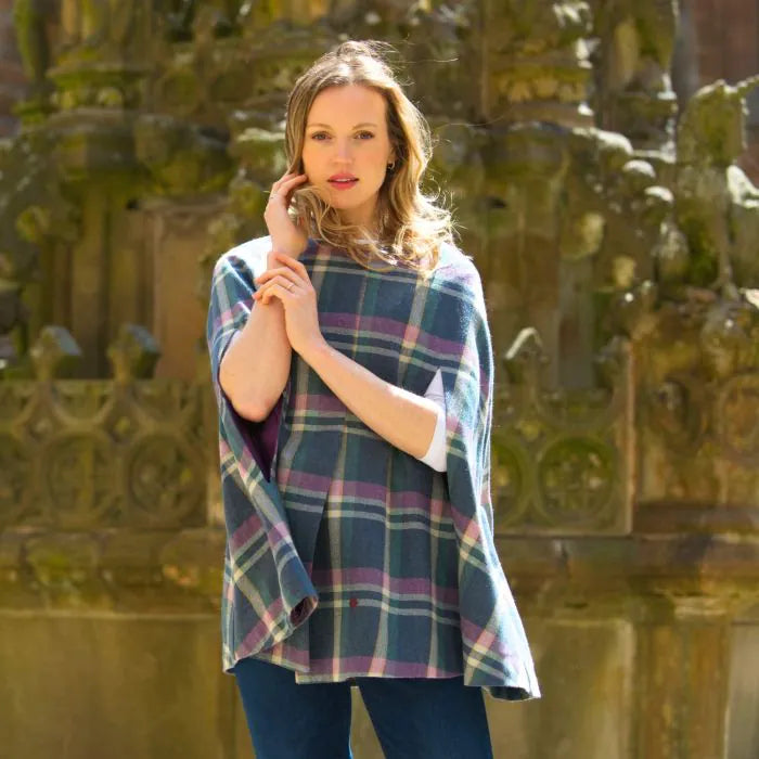 Front view of woman wearing Earth Squared Barnes Tweed Cape outdoors.