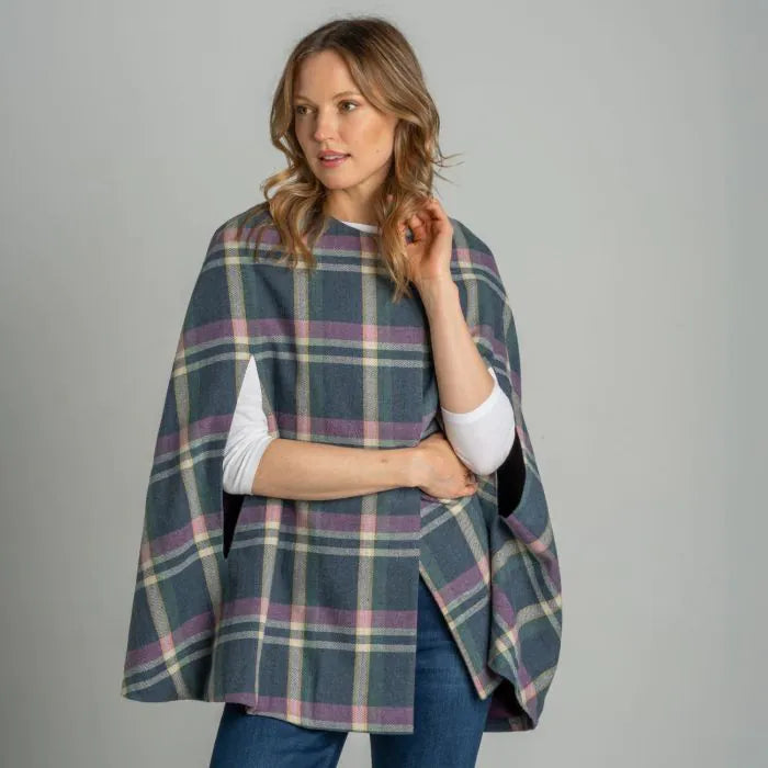 Front view of woman wearing Earth Squared Barnes Tweed Cape outdoors.
