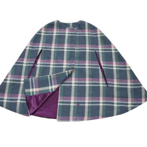 Flat lay of Earth Squared Barnes Tweed Cape showing plum lining.