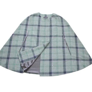 Flat lay of Gosford Tweed Cape showing satin grey lining and soft green check.