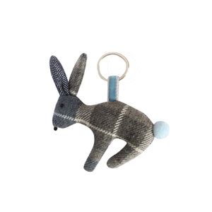 Earth Squared Rabbit Keyring featuring classic Humbie Tweed (blue and grey). The rabbit has a fluffy tail, embroidered eyes and whiskers. Attached to a silver keyring with a velour ribbon.