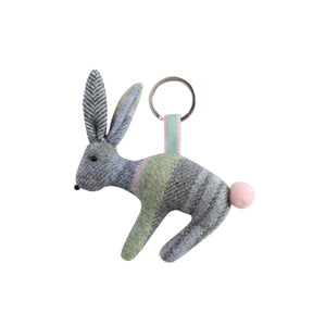 Adorable Earth Squared Tweed Rabbit Keyring crafted from Luffness Tweed (grey, green, blue, pink). Features a fluffy tail, embroidered eyes and whiskers, and a cute pink nose. Attached to a silver keyring with a velour ribbon.