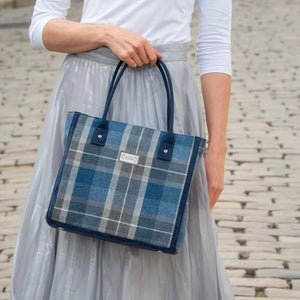 Earth Squared Tweed Tote Bag in Humbie Tweed (grey & blue) – Model showcases its stylish versatility.