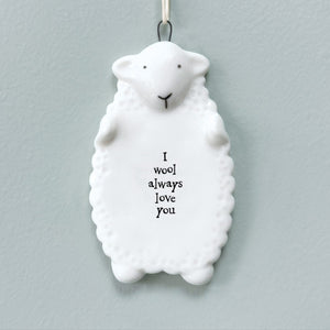 Porcelain sheep hanging plaque with the message ‘I wool always love you,’ featuring a cute rustic design and neutral hanging loop, perfect for gifting and home décor.