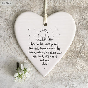 East of India Wobbly Round Heart porcelain hanging decoration placed against a textured background, featuring a bear and bird illustration with a sentimental remembrance quote.