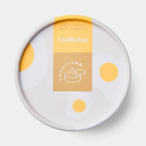 Lid of the Vanilla Egg CandleCan showing minimalist packaging design with yellow and white fried egg illustrations and the label reading “Vanilla Egg.”