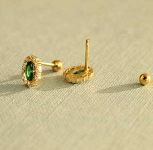 Pair of Tudor-inspired gold-plated stud earrings with emerald accent stones and screw-back fastening.