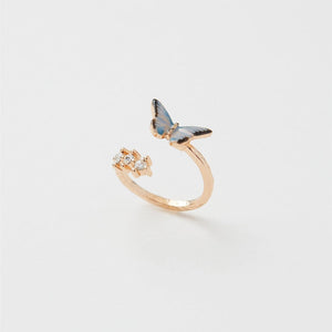 Gold adjustable Enamel Blue Butterfly Ring showing hand-painted butterfly and sparkling stones on white background.