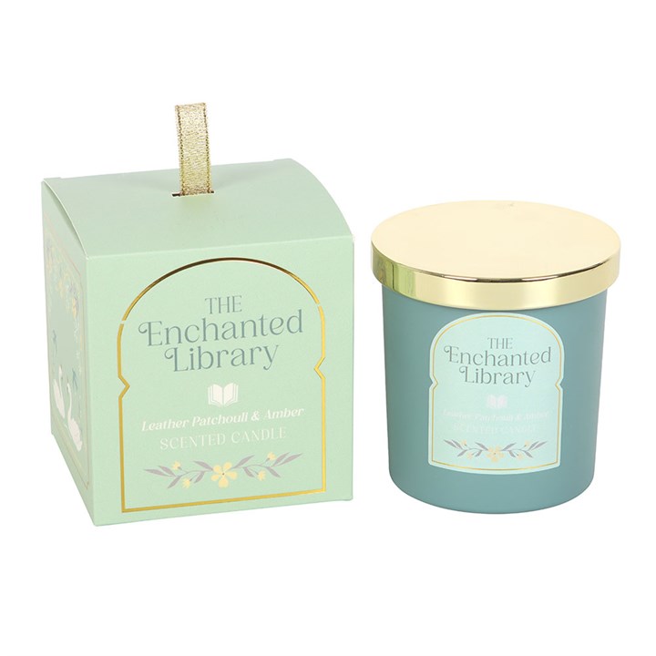 The Enchanted Library scented candle with gold lid beside illustrated green gift box.