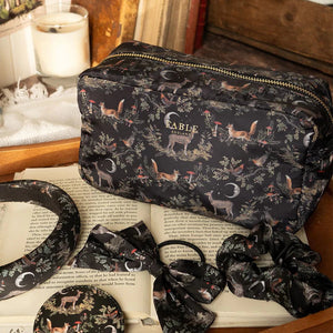 Fable England woodland pouch displayed with matching accessories including a scrunchie, bow, and mirror on a vintage-style setting.