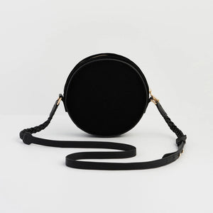 Back view of Fable England circular black velvet bag with adjustable crossbody strap.