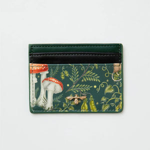 Front view of the Fable England Catherine Rowe Into The Woods Card Holder – A green vegan leather cardholder featuring a whimsical woodland print with toadstools, golden bee emblem, and delicate foliage detailing.